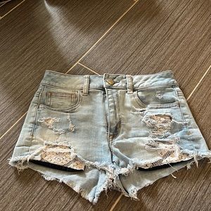 Light wash jean shorts, with a worn look to them